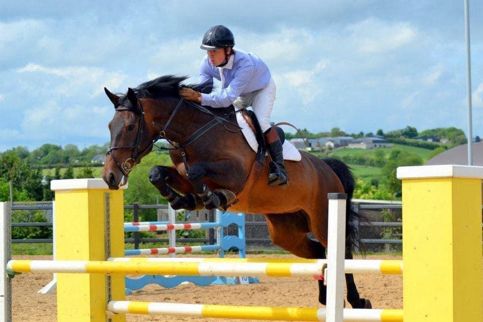 Liam McGarry competing in showjumping